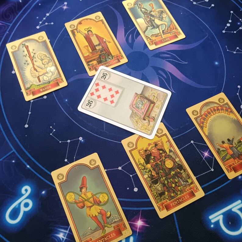 a collection of tarot cards spread out on a starry night sky background.