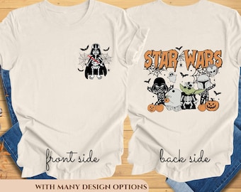 May include: A white t-shirt with a black and white illustration of Darth Vader on the front and a black and white illustration of Star Wars characters on the back. The back of the shirt also has the text "Star Wars" in black.