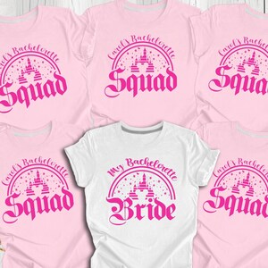 May include: Five pink t-shirts with a pink castle graphic and the text "Carol's Bachelorette Squad" and one white t-shirt with a pink castle graphic and the text "My Bachelorette Bride".