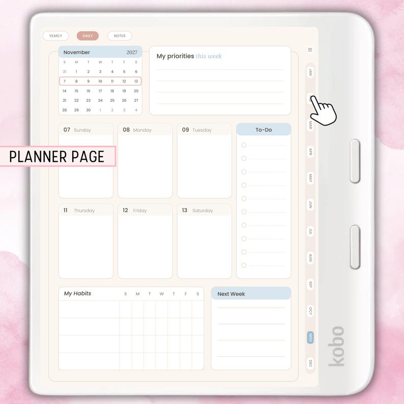 Peut inclure: Une liseuse Kobo blanche affichant une page de planificateur num&eacute;rique pour novembre 2027. L'&eacute;cran pr&eacute;sente un calendrier mensuel, un emploi du temps hebdomadaire avec des blocs quotidiens, une liste de t&acirc;ches, un suivi d'habitudes et des priorit&eacute;s.