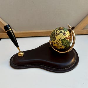 Vintage leather pen holder with a globe