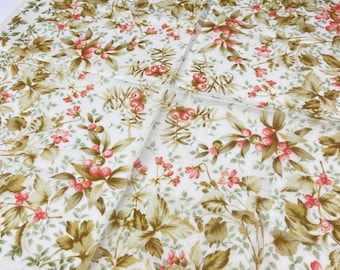 May include: A white fabric with a floral pattern featuring pink berries, small pink flowers, and green and brown leaves. The fabric is folded, showing the pattern in multiple directions. The overall design is reminiscent of a vintage botanical print.