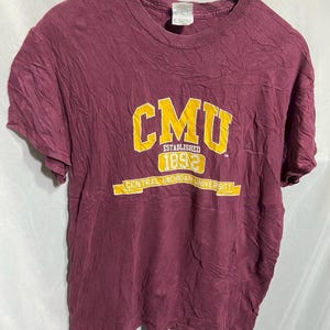 May include: A maroon t-shirt with a yellow graphic that says "CMU Established 1892 Central Michigan University".