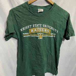 May include: Green short-sleeved t-shirt with the text "Wright State University Raiders" in gold and white lettering.