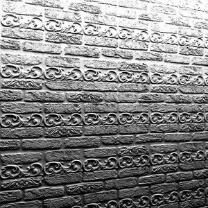May include: A grayscale brick wall with ornate, repeating scrollwork patterns. The bricks are rectangular and have a rough texture, with the decorative elements adding a touch of elegance. The wall is angled, showing depth and dimension.
