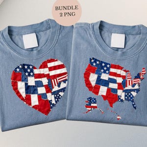 May include: Two light blue t-shirts. One has a heart design, the other the United States map, both in red, white, and blue patchwork. The shirts have blank white labels.