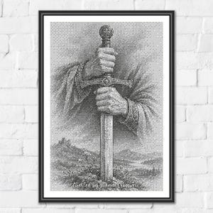 May include: A black and white cross stitch pattern print featuring a detailed illustration of two hands gripping the hilt of a sword planted into the ground. The artwork displays a landscape background and includes the text Charted by Sanna Cross Stitch.