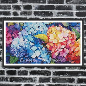 May include: A framed print of a watercolour painting depicting a cluster of hydrangeas. The artwork displays a variety of colours, including blue, purple, pink, yellow, and orange, with green leaves. The text "Charted by Zanna Crosswell" is visible.