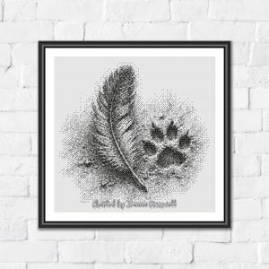 May include: A square framed wall art piece featuring a black and white stippled illustration of a single feather positioned next to a canine paw print. The design is rendered in a dot-work style on a light gray background with text at the bottom.