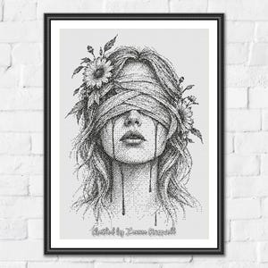 May include: A black and white stippled art print in a black frame featuring a person with eyes covered by a bandage, flowers tucked into their hair, and dark liquid dripping from beneath the bandage down their cheeks, with text at the bottom.