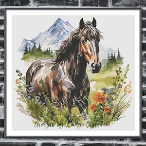 May include: Watercolor painting of a brown and white horse in a field of wildflowers. A mountain range and evergreen trees are in the background. The artwork is framed and signed "Charlan by Joanna Crosswell."