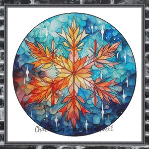 Könnte beinhalten: Ein gerahmtes, kreisförmiges Kunstwerk mit einem stilisierten Schneeflocken-Design. Die Schneeflocke ist in warmen Orange-, Gelb- und Rottönen gehalten, vor einem Hintergrund aus Blau und Türkis. Das Kunstwerk ist signiert mit "Charted by Zanna Crosswell".