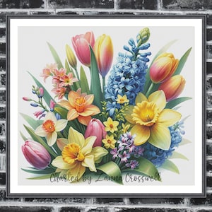 May include: A framed watercolor print of a vibrant floral bouquet. The arrangement features yellow daffodils, pink and yellow tulips, blue hyacinths, and other colorful blossoms. The text "Charted by Lanna Crosswell" is at the bottom.