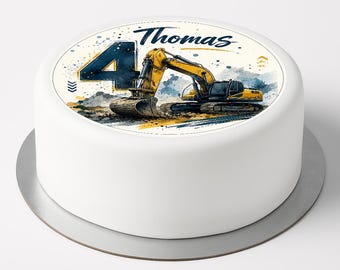 May include: A round white cake topper featuring a yellow excavator construction vehicle, the number 4 in dark blue, and the name Thomas in blue script. The design includes watercolor-style splashes and a textured ground illustration.