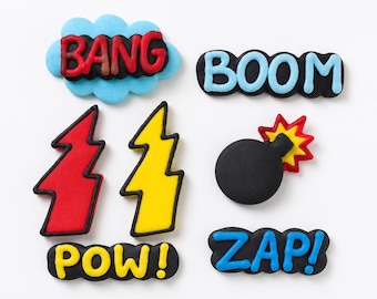 May include: A set of six comic book-themed decorations featuring the words BANG, BOOM, POW, and ZAP, along with two lightning bolt shapes and a round black bomb with a red and yellow fuse, all rendered in vibrant colors with bold black outlines.