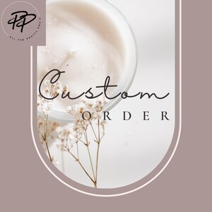 May include: A white candle jar with a white background and a sprig of white flowers. The text "Custom Order" is written in black cursive script.