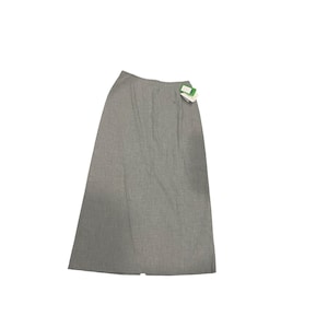 May include: A pale grey, floor-length skirt with a slight A-line cut. The skirt has a subtle textured appearance and a small slit at the bottom hem. A tag with green and white details is attached near the waist.