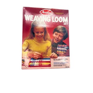 May include: A vintage Avalon Weaving Loom Set box with a red background. The box features two children working with the loom. The text "WEAVING LOOM SET" is prominently displayed. The set includes a sturdy loom and colored loops.