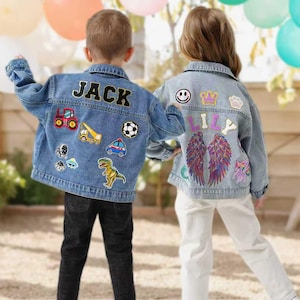May include: Two children wearing denim jackets with patches. One jacket says "JACK" and features patches of a tractor, a soccer ball, and a dinosaur. The other jacket says "LILY" and has patches of wings, a crown, and a smiley face.