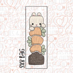 May include: A cookie cutter set featuring a bunny holding a stack of carrots. The bunny is white with pink cheeks and a pink nose. The carrots are orange and green. The cookie cutter set is 3x8 inches.