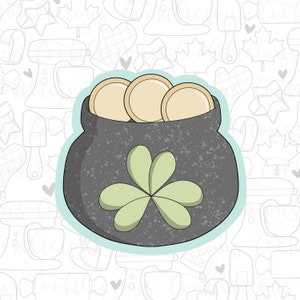 May include: A grey pot with a green four-leaf clover design, filled with gold coins. The pot is outlined in blue and set against a white background with a pattern of baking-related items.