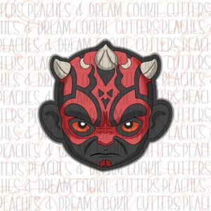 May include: A red and black cartoon illustration of Darth Maul's head with horns.