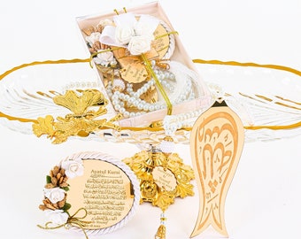 May include: A white and gold decorative tray with a white and gold prayer rug, a white and gold prayer beads, a white and gold decorative plaque with Arabic calligraphy, and a white and gold decorative box with the text "Ayatul Kursi" and "Sumeyye & Yousef" in gold lettering.