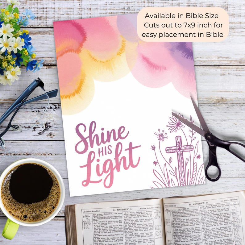 May include: A print with watercolor clouds in pink, yellow, and purple hues. The text "Shine His Light" is in a script font. A cross and floral design are on the right. The print is available in Bible size, cutting out to 7x9 inches.