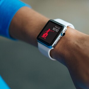 May include: A white Apple Watch with a black face displaying the time 10:10 and the date THU 12. A red stick figure is shown on the screen.