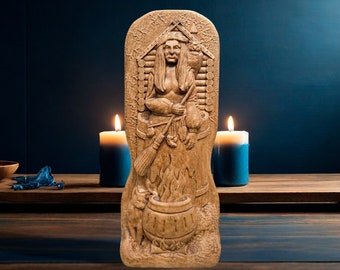 May include: A wooden carving of a woman with a broom and cauldron, standing in front of a log cabin. The carving is painted in shades of brown and has a rustic, antique look.