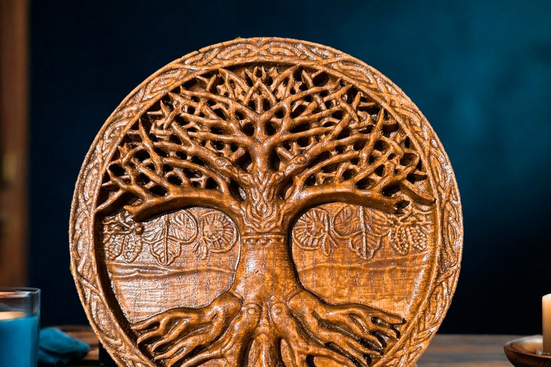 May include: A circular wooden wall hanging featuring an intricately carved tree of life. The tree has detailed branches and roots, and the carving is surrounded by a Celtic knot border.