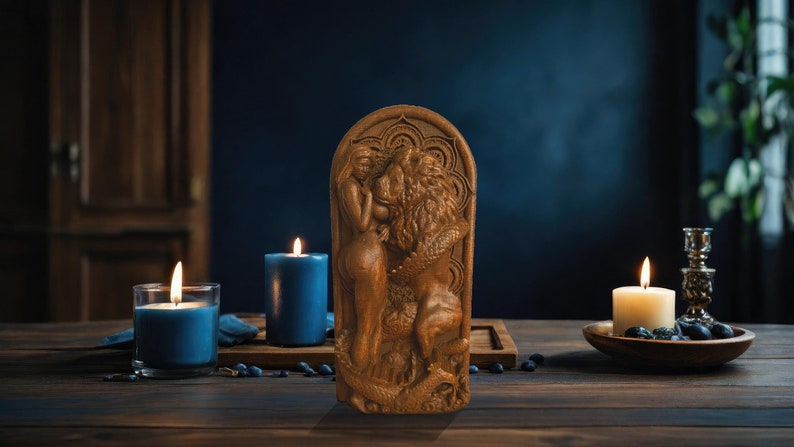 May include: A wooden sculpture of a woman and a lion, carved in a detailed style. The sculpture is set against a dark blue background with candles and other decorative elements.