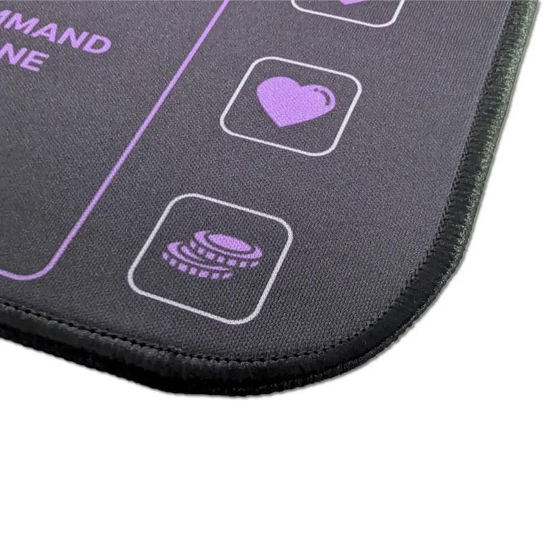 Close-up of the stitched edge and purple icons on the Commander Mini Dashboard playmat