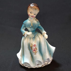 Vintage Victorian Era Brunette Woman in a Turquoise Blue Dress with Ulster and Flowers