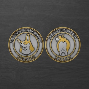 May include: Two round, silver-colored metal coins with gold-colored rims. One coin features a corgi head, the other a corgi's rear. Text on the coins reads "Evoke the Art Heads!" and "Decked Out Tails!"