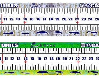 May include: A white measuring tape with black markings and a blue and green background. The tape measures up to 35 inches and features the text "@CAST LURES".