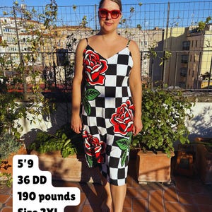 May include: A sleeveless midi dress featuring a black and white checkered pattern with large red rose graphics and green leaves. The dress has thin spaghetti straps and a V-neckline. Text on the image reads: 5'9, 36 DD, 190 pounds, Size 2XL.