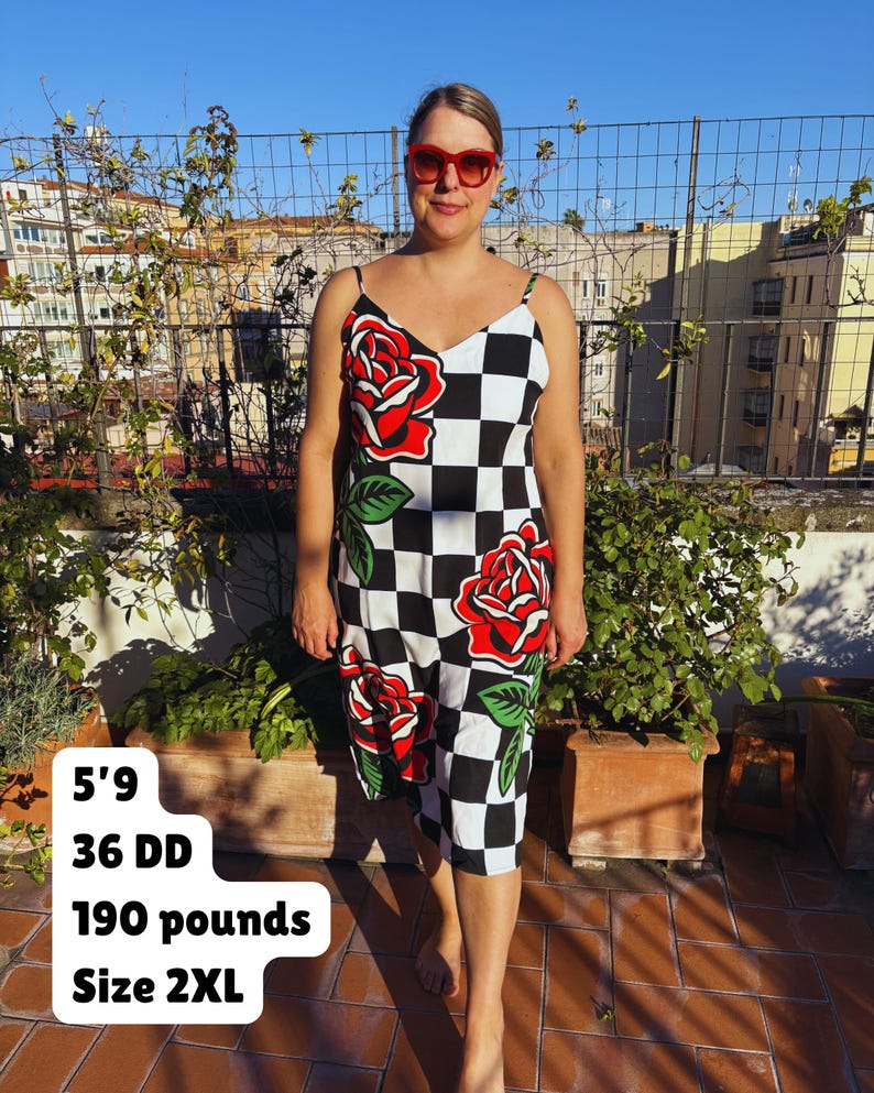 May include: A sleeveless midi dress featuring a black and white checkered pattern with large red rose graphics and green leaves. The dress has thin spaghetti straps and a V-neckline. Text on the image reads: 5'9, 36 DD, 190 pounds, Size 2XL.