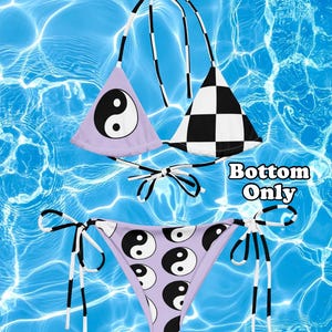 May include: A two-piece bikini set featuring a light purple triangle top with a black and white yin-yang symbol, a black and white checkered triangle top, and matching light purple bikini bottoms with a yin-yang pattern. Text reads Bottom Only.