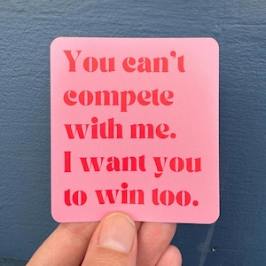 Może przedstawiać: Różowa kwadratowa karta z tekstem "You can't compete with me. I want you to win too." w czerwonych literach.