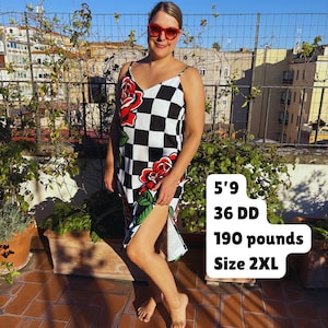 May include: A sleeveless midi dress featuring a black and white checkered pattern with large red rose graphics. The dress has thin spaghetti straps and a V-neckline. Text on the image reads: 5'9, 36 DD, 190 pounds, Size 2XL.