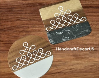 May include: Two round wooden coasters with a white marble top. The coasters feature a white geometric design. The coasters are on a wooden surface. HandcraftDecorUS is written in white text on the surface.