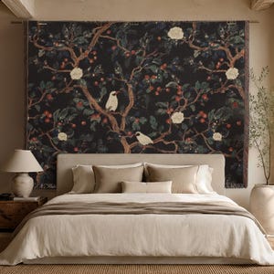 May include: A rectangular wall tapestry featuring a dark black background with a repeating pattern of brown tree branches, green leaves, small red berries, and white flowers, interspersed with white birds perched on the branches.