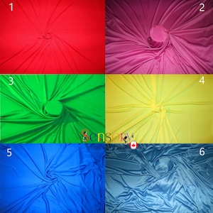 May include: Six different colours of fabric swirled into a spiral shape. The colours are red, pink, green, yellow, blue, and light blue.