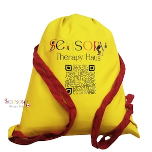 May include: Yellow drawstring bag with red drawstrings. The bag has a logo that says "Sensory Therapy Haus" and a black and white QR code.