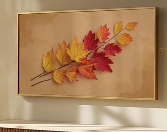 May include: A framed print of a branch with fall leaves in shades of red, orange, and yellow against a beige background. The print is hanging on a wall above a light wood cabinet with a slatted front.