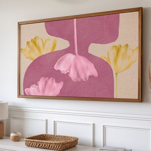 May include: A framed abstract art print featuring pink and yellow flowers on a beige and pink background.