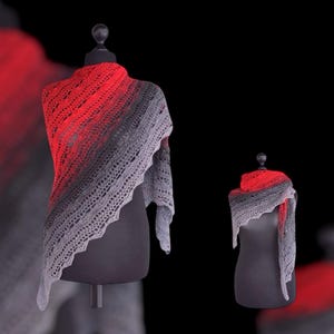 May include: A gray and red crocheted shawl displayed on two mannequins. The shawl is a gradient of red to gray.