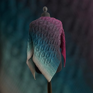 May include: A triangular shawl with a gradient of purple, blue, and green colors. The shawl is knitted with a cable stitch pattern.