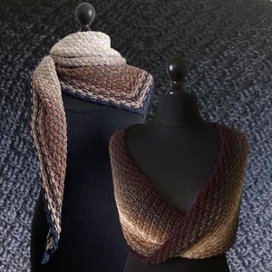 May include: Two crocheted shawls, one in a brown, beige and blue colour scheme and the other in a brown, beige and burgundy colour scheme.